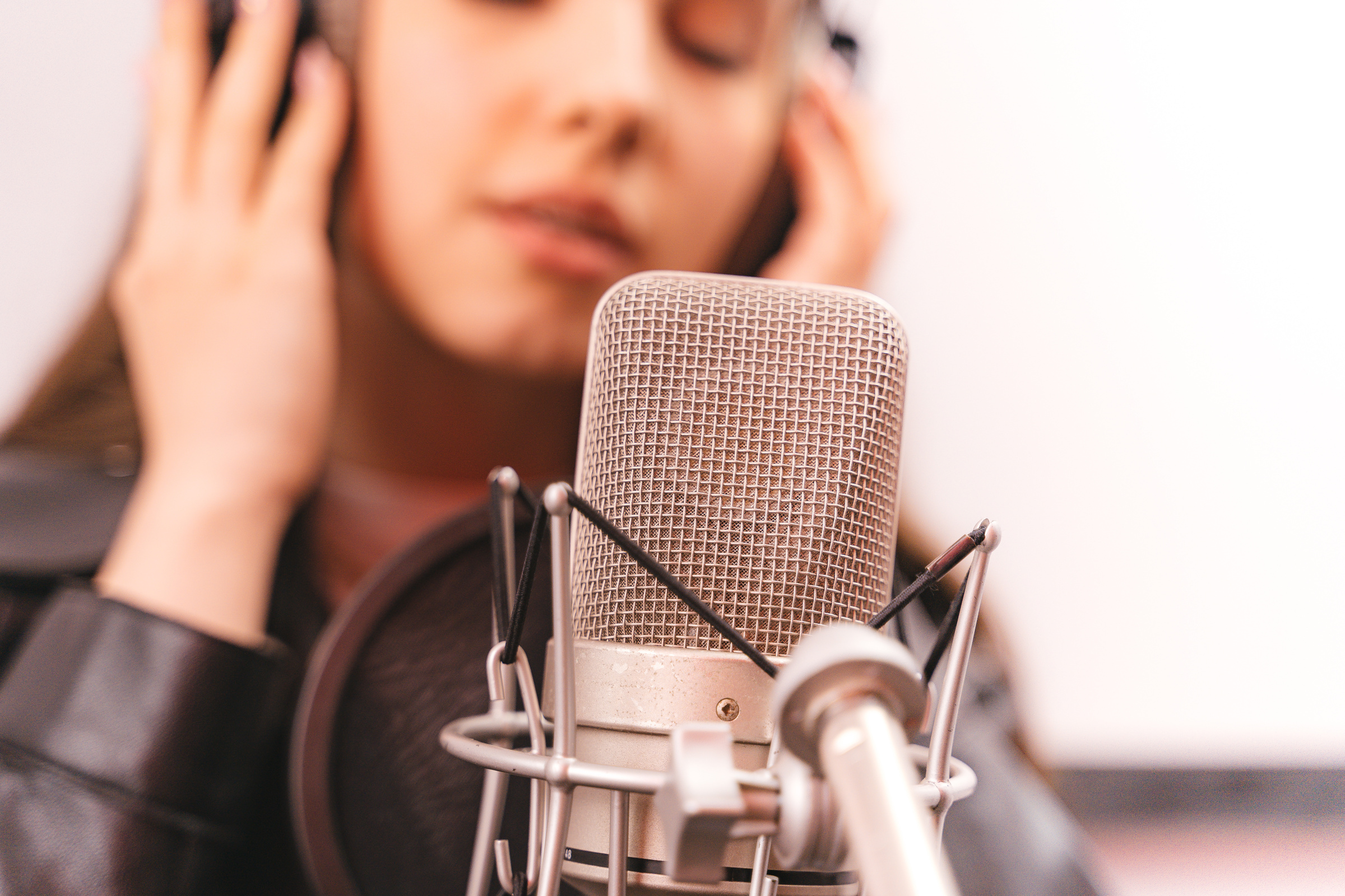 A Woman Singing on a Microphone